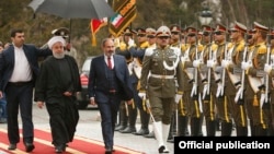 Iran - Iranian President Hassan Rouhani and Armenian Prime Minister Nikol Pashinian inspect an Iranian honor guard at a welcoming ceremony in Tehran, February 27, 2019.