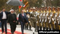 Iran - Iranian President Hassan Rouhani and Armenian Prime Minister Nikol Pashinian inspect an Iranian honor guard at a welcoming ceremony in Tehran, February 27, 2019.