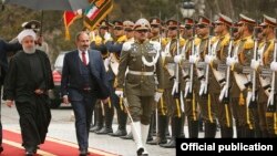 Iran - Iranian President Hassan Rouhani and Armenian Prime Minister Nikol Pashinian inspect an Iranian honor guard at a welcoming ceremony in Tehran, February 27, 2019.