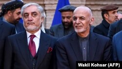 FILE: Abdullah Abdullah and Afghan President Ashraf Ghani (R) during an event in Kabul on February 29.