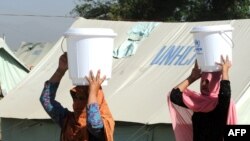 Internally displaced women, fleeing from military operations against Taliban militants in the Swat Valley and Buner, at a makeshift camp in Mardan