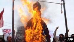 Pakistani protesters burn an effigy of CIA contractor Raymond Davis during a demonstration in Lahore on February 28.