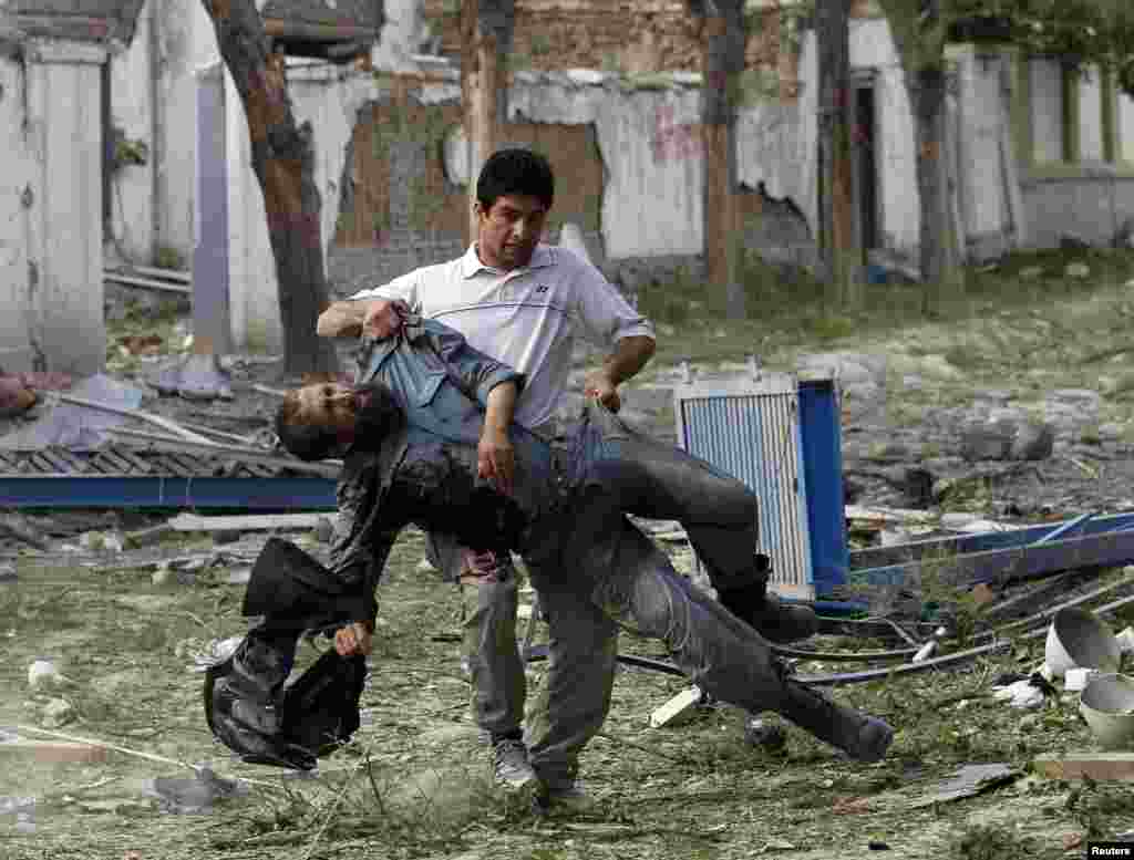 A wounded Afghan policeman is carried away from the site of an explosion in Kabul on May 24. (Reuters/Omar Sobhani)