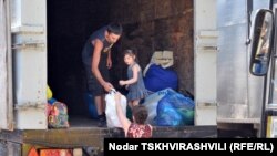 Authorities evicting displaced persons from a military building at Vake-Saburtalo road in Tbilisi on August 11.