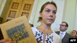 Vira Savchenko holds a book written in prison by her sister Nadia during its presentation at the Ukrainian parliament in Kyiv earlier this year.