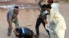 Pakistani opposition protesters beat a riot policeman during an anti-government protest in Islamabad, September 1, 2014.