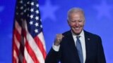In this file photo taken early on November 4, 2020 Democratic presidential nominee Joe Biden gestures after speaking during election night at the Chase Center in Wilmington, Delaware.