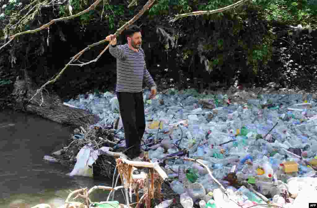 Srbija - Amaterski ekolog Srboljub Pešić posmatra smeće rijeke Morave, nedaleko od Vranja, 15. maj 2013.  Foto: AFP / Saša Đorđević  