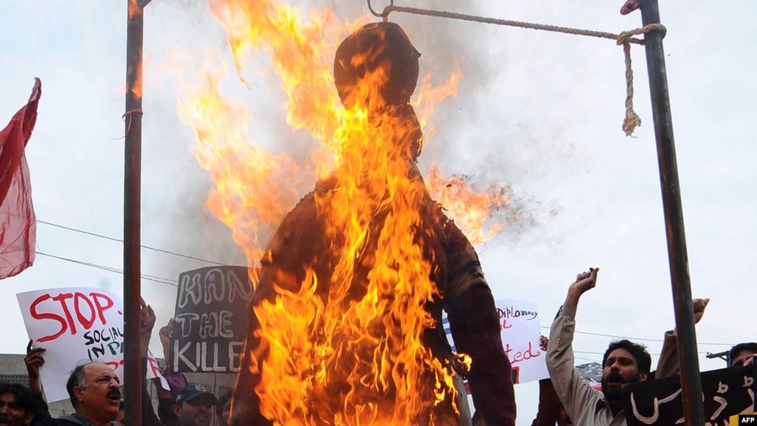 Pakistani protesters burn an effigy of CIA contractor Raymond Davis during a demonstration in Lahore on February 28.