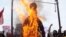 Pakistani protesters burn an effigy of CIA contractor Raymond Davis during a demonstration in Lahore on February 28.
