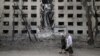 Women walk past a hostel destroyed during a missile attack in the town of Selydove, in Ukraine's eastern Donetsk region, on April 14.