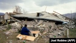 ARMENIA -- A Survivor sits near his house in the devastated town of Spitak, on December 11, 1988