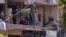 Police officers and emergency personnel work at the site of an Israeli strike on the southern suburbs of Beirut on June 14.