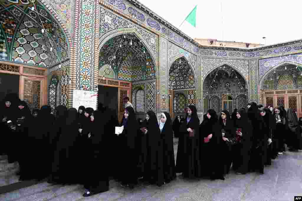 Women wait to vote at a polling station at the Massoumeh shrine in the holy city of Qom.