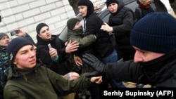 Police clash with far-right activists after they attacked LGBT participants during a march to mark International Women's Day in Kyiv on March 8, 2018.