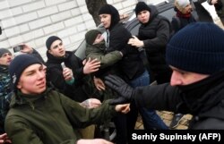Police clash with far-right activists after they attacked LGBT participants during a march to mark International Women's Day in Kyiv on March 8, 2018.