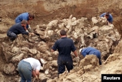 A mass grave of some of the victims of the Srebrenica genocide being uncovered in 1996.