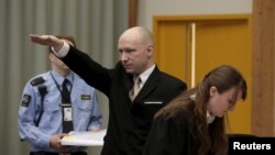 Mass killer Anders Behring Breivik raises his arm in a Nazi salute as he enters the court room in Norway's Skien prison on March 15.