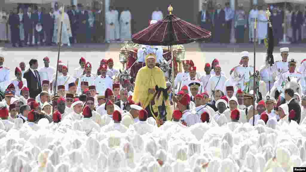 Morocco&#39;s King Mohammed VI (center) parades on horseback during celebrations marking the 13th anniversary of his accession to the throne in Rabat on August 21. (REUTERS/Maghreb Arabe)