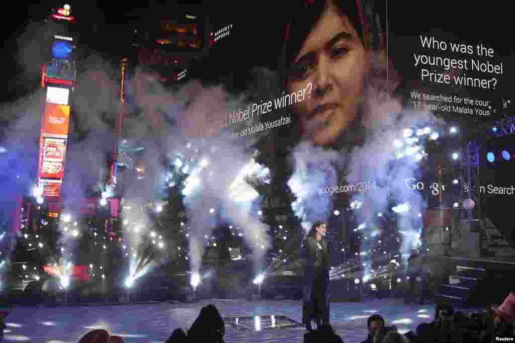 U.S. - Singer Idina Menzel performs as an image of schoolgirl activist Malala Yousafzai is projected on a screen in Times Square on New Year's Eve in New York December 31, 2014