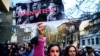 A woman holds up a poster with an image of Josef Stalin, Vladimir Putin, and Adolf Hitler with the inscription "Monsters" during a demonstration to support Ukraine in front of Russia's cultural center in downtown Sofia in April.