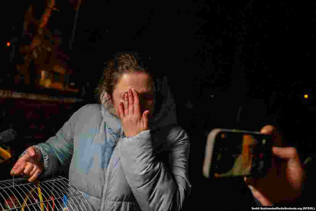 A woman reacts in the aftermath of the strike on the apartment block in Kyiv's Dniprovskiy district.