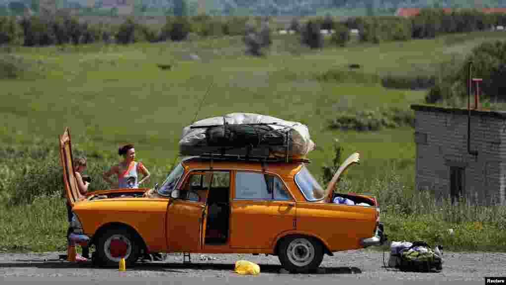 Ukraijina - Ovaj automobil nije izdržao visoke temperaturene, pokvario se u predgrađu Donetska, 21. juni, 2012. Foto: REUTERS / Alessandro Bianchiheir