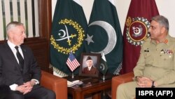 FILE: Pakistani Army Chief General Qamar Javed Bajwa (R) speaks with U.S. Defense Secretary Jim Mattis in December 2017.