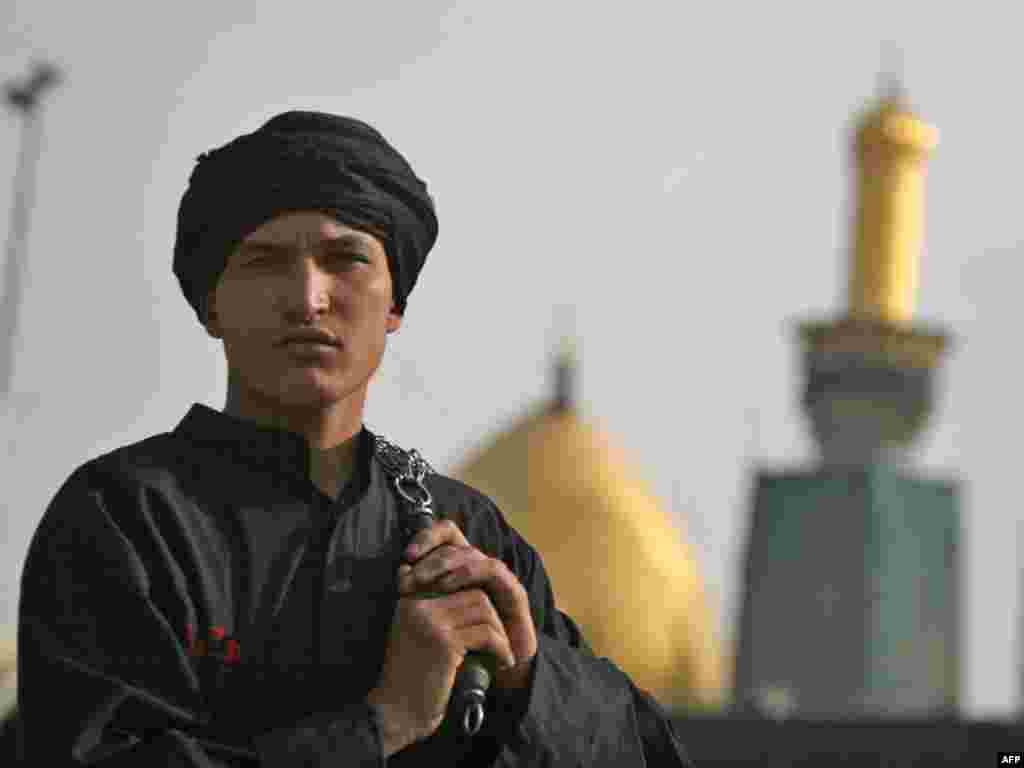 A Shi'ite man in front of the Imam Hussein Shrine in the holy city of Karbala, holding the chains with which he will flagellate himself in one of the most recognizable ceremonies of Ashura, one of the holiest days on the Shi'ite calendar (see also RFE/RL video of Afghan Ashura festivities here ).