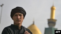 A Shi'ite Muslim in Iraq holds chains used in self-flagellation outside the Imam Hussein shrine during the Ashura observation in Karbala in December 2009.