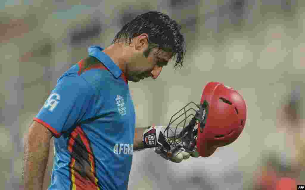 Afghanistan captain Asghar Stanikzai reacts as he walks to the pavilion after his dismissal during the World T20 cricket tournament match between Sri Lanka and Afghanistan on March 17. 