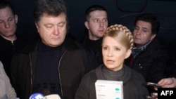 Prime Minister Yulia Tymoshenko (right) holds up packs of the Tamiflu antiviral medicine.