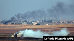 Smoke billows from targets inside Syria during bombardment by Turkish forces on October 9.