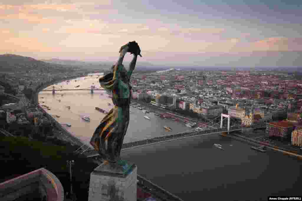 Budapest, Hungary. The Liberty Statue, overlooking Budapest. Built in 1947 for the &quot;Liberating Soviet Heroes,&quot; the inscription was amended swiftly after the U.S.S.R. collapsed. Today the monument is dedicated &quot;To the memory of all those who sacrificed their lives for the independence, freedom, and prosperity of Hungary.&quot;