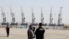 Harbor security men stand guard during an inauguration ceremony of new equipment and infrastructure at Shahid Beheshti Port in the Southeastern Iranian coastal city of Chabahar, on the Gulf of Oman, February 25, 2019