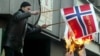 Protester burning Danish, Norwegian flags in Sarajevo on 8 February