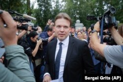 Lawyer Maksim Znak, a member of the opposition's Coordination Council, is surrounded by reporters upon arriving at the Investigative Committee headquarters, where he was summoned for questioning in Minsk on August 21. He was arrested on September 9.