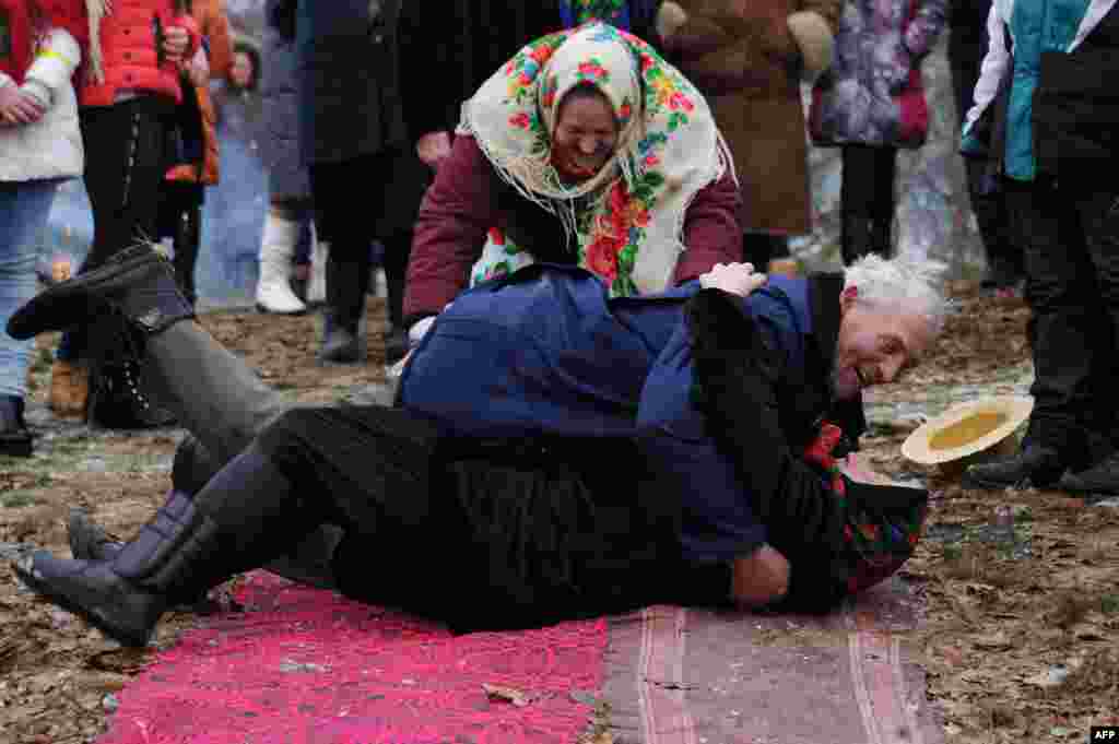 Villagers roll over as they take part in Shrovetide celebrations in the village of Tonezh, some 280 kilometers from Minsk, Belarus. (AFP/Sergei Gapon)