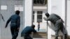 Afghan policemen try to rescue a child at the site of a suicide attack followed by a clash between Afghan forces and insurgents after an attack on a Shi&#39;ite Muslim mosque in Kabul on August 25. (Reuters/Omar Sobhani)