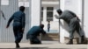 Afghan policemen try to rescue a child after an attack on a Shi'ite Muslim mosque in Kabul on August 25.