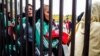 Iranian women waiting behind the gates before a Perspolis match in Azadi Stadium on November 10, 2018.