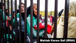 Iranian women waiting behind the gates before a Perspolis match in Azadi Stadium on November 10, 2018.