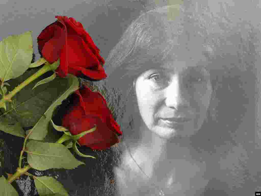 Flowers cover a photo of slain journalist and human rights activist Natalya Estemirova at a protest rally in Moscow on July 16, 2009.