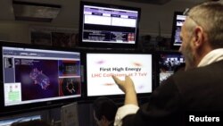 Researchers at work in CERN's CMS experience control room in Meyrin on March 30.