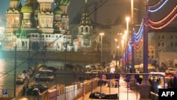 The body of Russian opposition leader Boris Nemtsov, covered with a plastic sheet, lies on Moskvoretsky Bridge near St. Basil Cathedral in central Moscow after he was killed late on February 27.