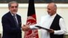 Afghan presidential candidates Abdullah Abdullah (left) and Ashraf Ghani shake hands after signing a power-sharing agreement at the Presidential Palace in Kabul on September 21.