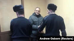 Dennis Christensen (center), a Jehovah's Witness, has been sentenced to six years in Russia on extremism charges.