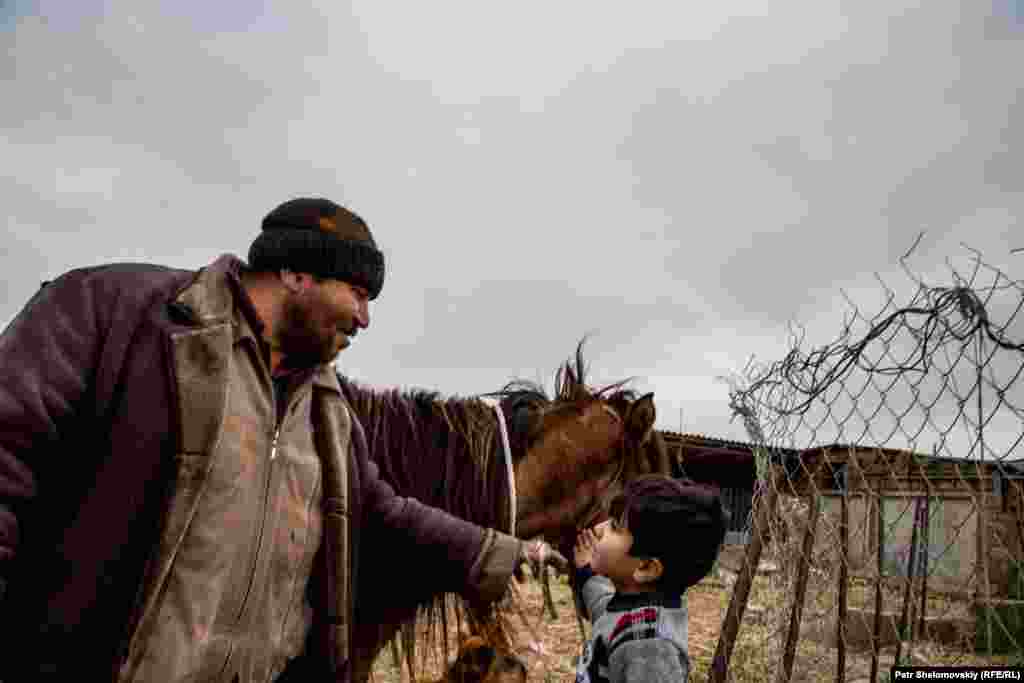 Ilshan, a sheperd, and his son Adygezel at their farm near Novkhany.