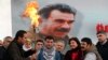 An image of militant Kurdish leader Abdullah Ocalan provides the backdrop for pro-Kurdish activists lighting a Norouz fire in Istanbul on March 17.