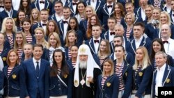 Russian Olympic team members pose for a family photo with Patriarch Kirill (center) at Uspensky Cathedral in Moscow on July 27.